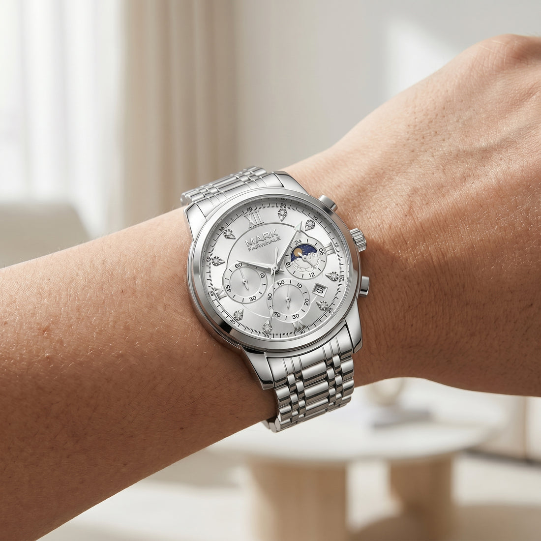 Silver wristwatch with detailed face on a person&