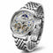 Silver wristwatch with intricate design on a white background