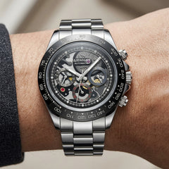 Silver wristwatch with visible brand name on a person's wrist against a neutral background