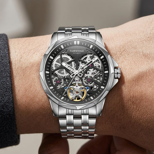 Silver wristwatch with visible mechanical components on a wrist, brand &