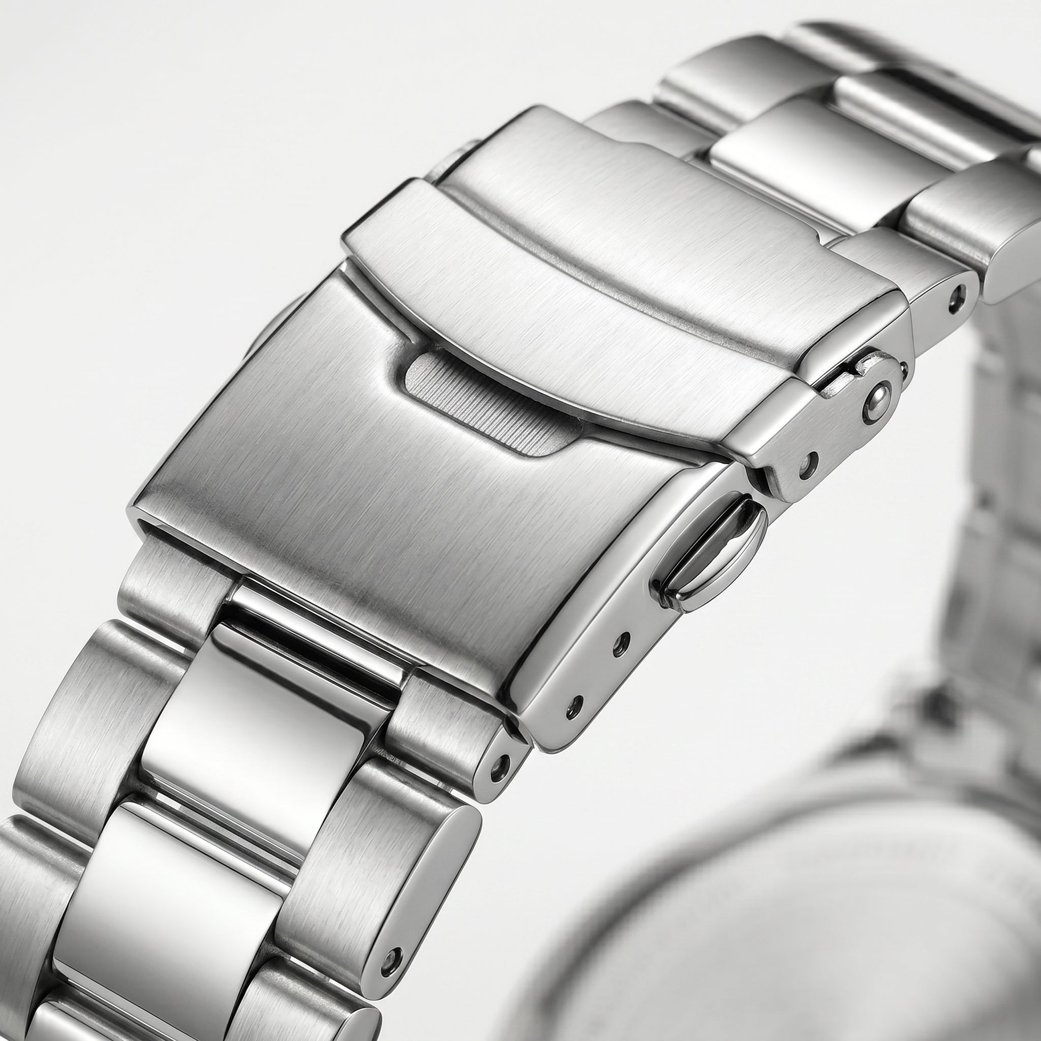 Stainless steel watch clasp macro close-up with brushed and polished metal bracelet links