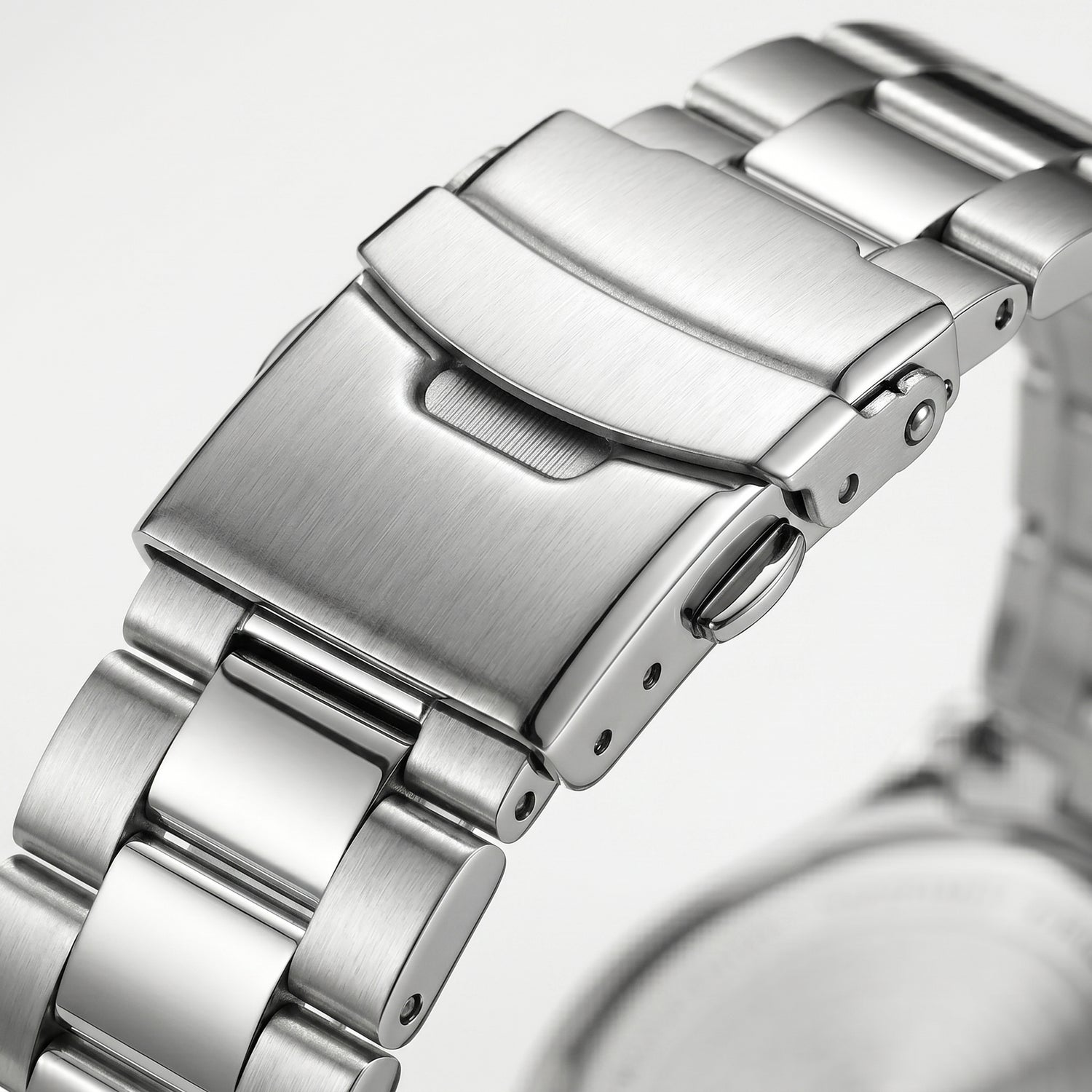 Stainless steel watch clasp macro close-up with brushed and polished metal bracelet links
