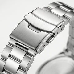 Stainless steel watch clasp macro close-up with brushed and polished metal bracelet links