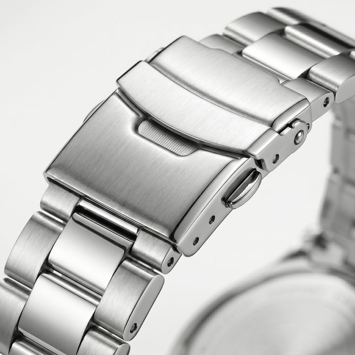 Stainless steel watch clasp macro close-up with brushed and polished metal bracelet links