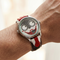 Watch with a unique face design on a wrist against a neutral background