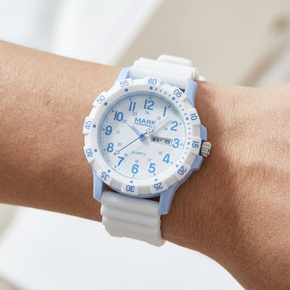 White and blue watch on a wrist with a blurred background