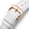 White leather watch strap with a rose gold buckle on a white background
