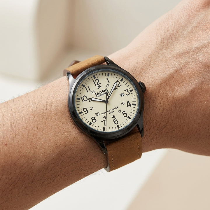 Wrist wearing a watch with a brown leather strap and white face.