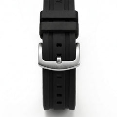 Close-up of black rubber watch strap with brushed stainless steel buckle