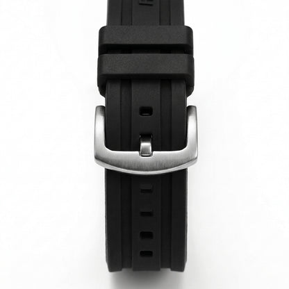 Close-up of black rubber watch strap with brushed stainless steel buckle