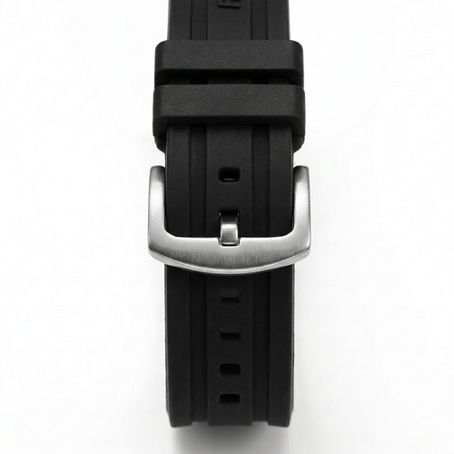 Close-up of black rubber watch strap with brushed stainless steel buckle