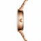 Mark Fairwhale 3200 CHROM - Rose gold watch on a blurred background with bokeh lights